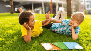 système scolaire-fiable-île-Maurice-smarttraveller Deux enfants jouant et étudiant en plein air dans un environnement sécurisé, illustrant la qualité de vie et le système scolaire bienveillant à l’île Maurice pour les familles expatriées